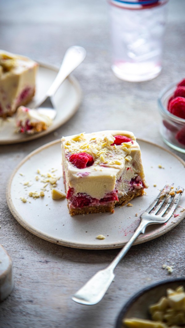 Raspberry & White Chocolate Cheesecake Bars | For a sweet summer pick me up, these cheesecake bars here are no-bake, take minimal fuss and are so easy to make using the best of ingredients from your local dunnesstores. They are a riff off a recipe I’ve been making for years due to the oohs and aahs they almost always garner! adServes: 12
Time: 30 mins + chilling time

200g plain digestive biscuits
100g unsalted butter
400g good-quality white chocolate, broken into pieces
250g mascarpone cheese 
250g full-fat cream cheese
200ml double cream
250g raspberries, half mashed to a puree and half whole

Bash the biscuits in a resealable bag with a rolling pin until you have fine crumbs.
Melt the butter in a large saucepan then add the biscuit crumbs and mix to combine. Tip the butter and biscuit mix into the base of a lined 20cm/8” cake tin. Pack in the biscuit mix with a spoon or a meat mallet.
Place the chocolate in a heatproof bowl, in a single layer if you can, over a pan of barely simmering water, making sure the base of the bowl does not touch the water, and gently melt, without stirring. You can tell it is melted when you gently nudge a square and it will dissolve. Only then stir together and set aside. 
Beat the cream cheese, cream and mascarpone in a large bowl with an electric hand whisk, then, with a spatula, stir through the white chocolate and pour over the biscuit base in the tin.
Dollop the pureed raspberries over the top of the cheesecake and using a spoon, swirl the raspberries into the cream mix. Dot in the remaining whole raspberries, lightly pushing them into the mix. 
Cover and place in the fridge to chill and set for at least 2 or 3 hours.
Remove the cheesecake from the tin and cut into bars then serve.